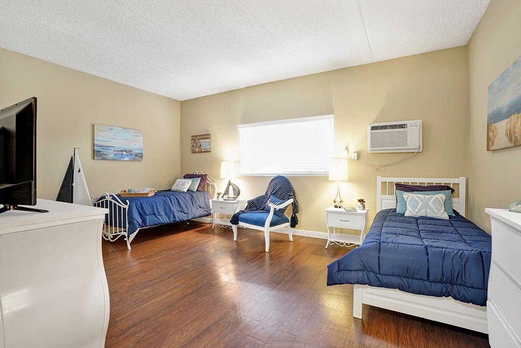 Interior view of a furnished bedroom at Arbor Palms Senior Living Community in Anaheim.