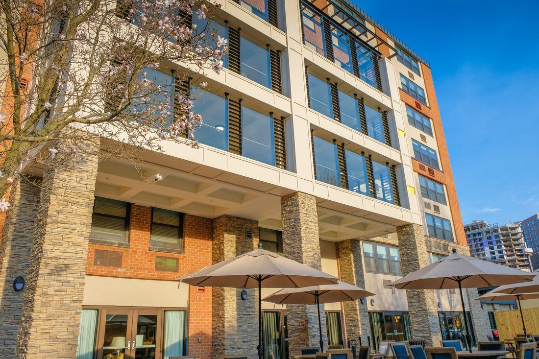 High-rise condo building of Sunrise of Bethesda senior living community in an urban city.