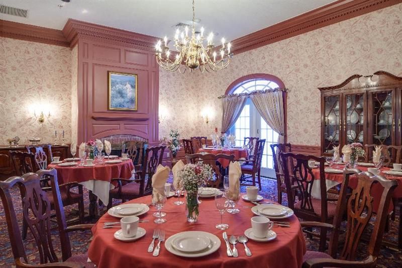 Senior living community dining room at Langdon Place of Exeter with elegant decor and furniture.