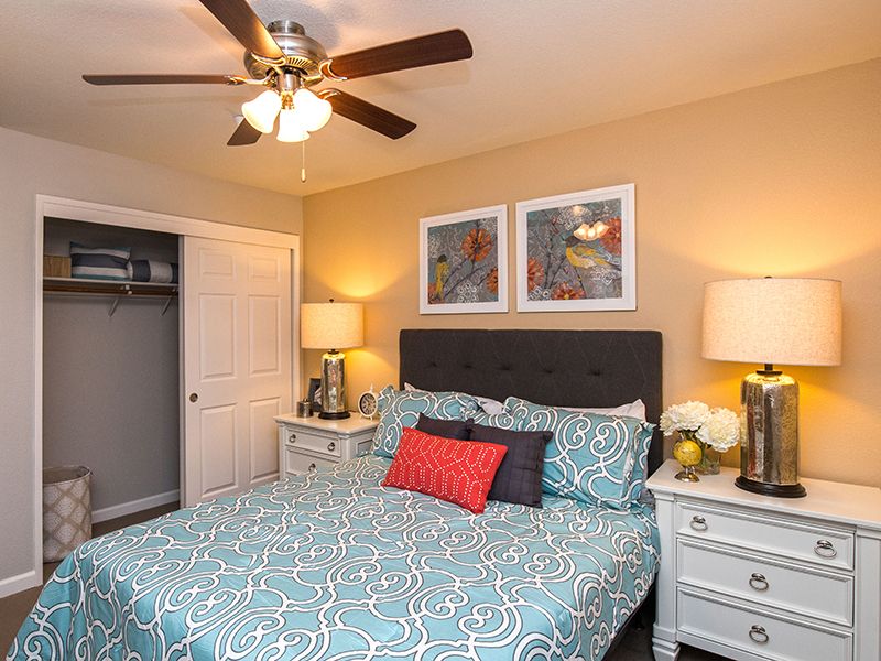 Senior living bedroom interior at The Terraces of Roseville, featuring furniture and appliances.