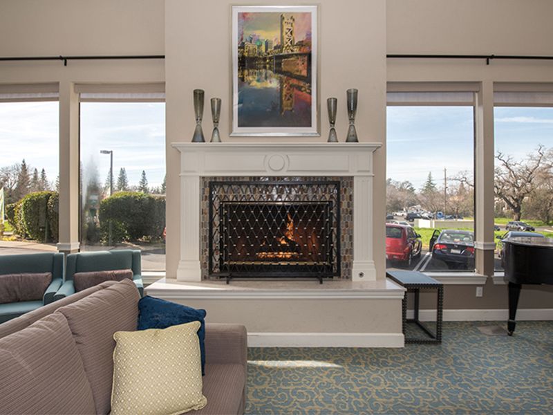 Interior view of The Terraces of Roseville senior living community featuring a cozy fireplace.