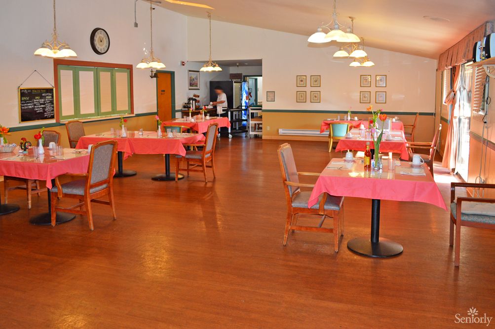 Interior view of Lincoln Villa senior living community featuring hardwood floors and dining area.