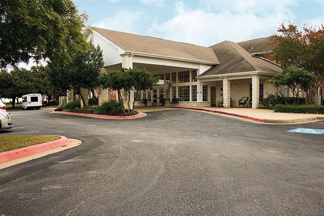 Brookdale Round Rock senior living community with modern architecture, urban streets, and outdoor furniture.