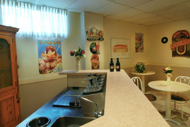 Interior view of Princeton Rehab & Health Care Center featuring dining area, kitchen, and living room.