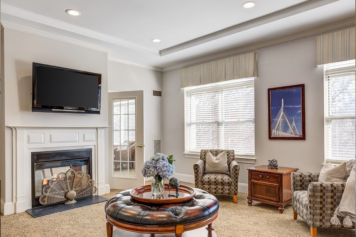 Interior view of Chestnut Park at Cleveland Circle senior living room with modern decor and electronics.