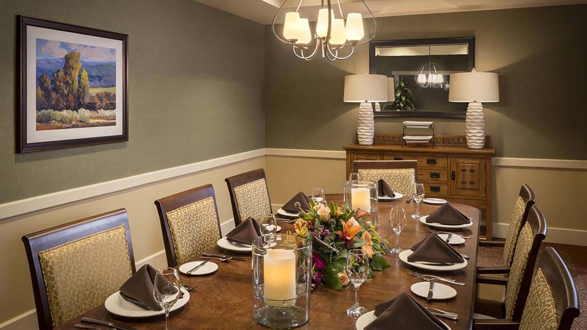 Interior view of Atria Del Sol senior living community featuring elegant dining room decor.