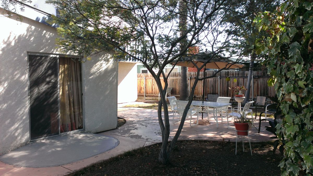 Senior living community house with patio, garden, pergola, and interior design features.