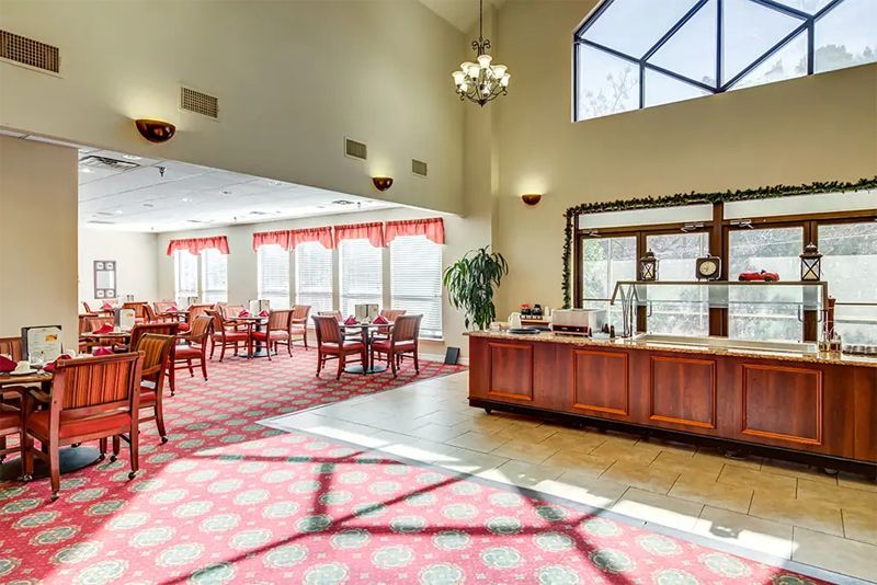 Indoor view of the elegant Continental Retirement Community featuring lounge furniture, chandeliers and foyer.