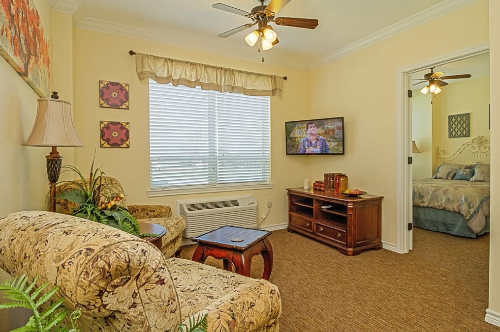 Senior living room interior at Midtowne with modern decor, electronics, and residents.
