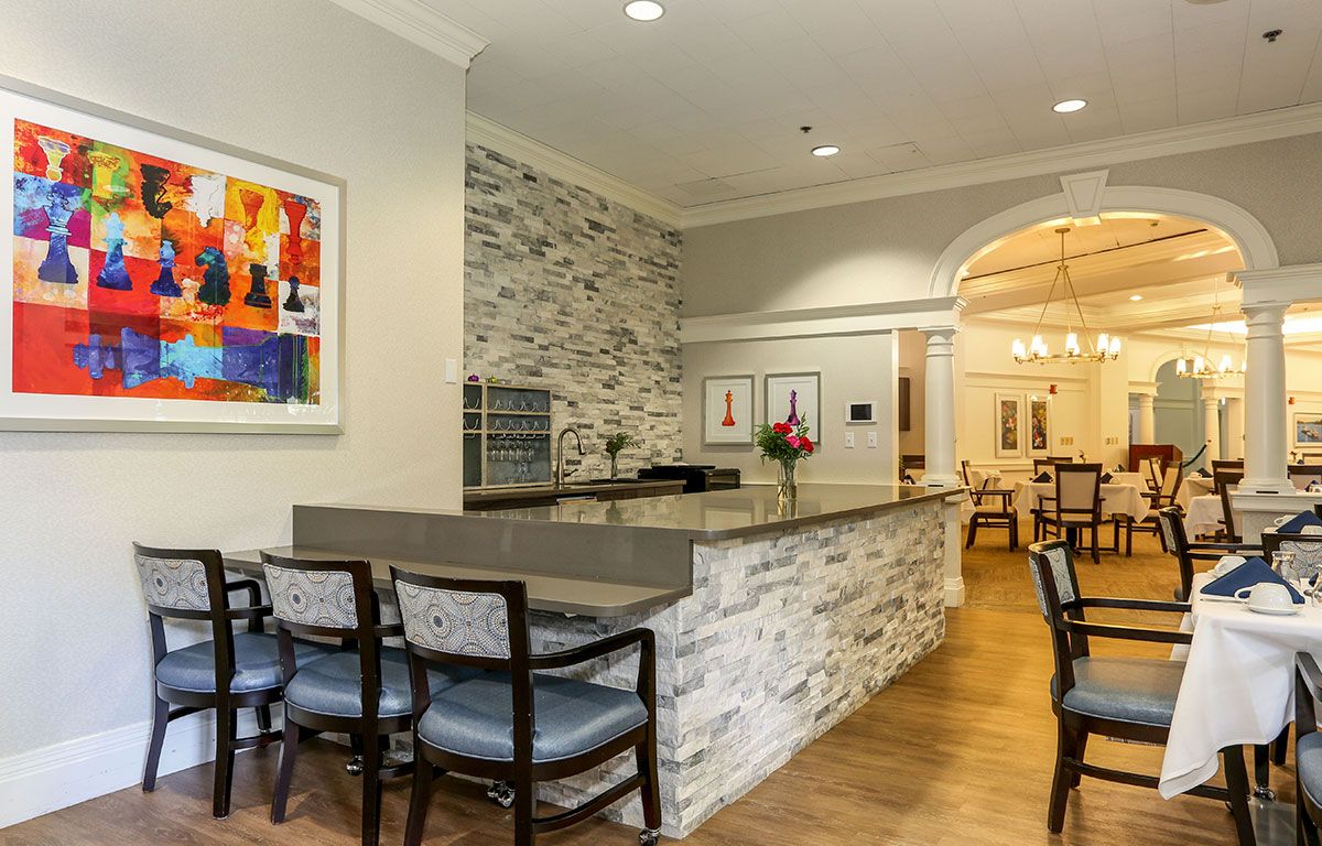 Senior living community Wingate Residences, showcasing its architectural design, dining room furniture, and interior.