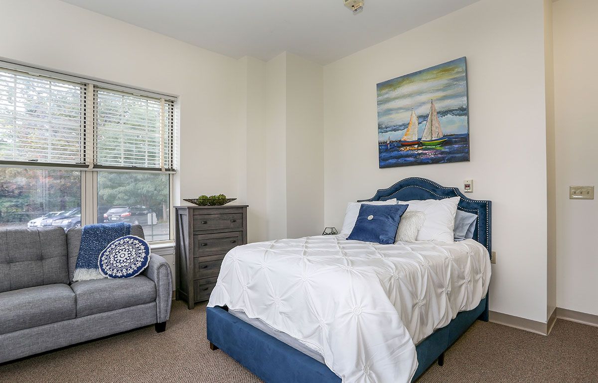 Interior view of a cozy bedroom at Wingate Residences, featuring elegant home decor and art.