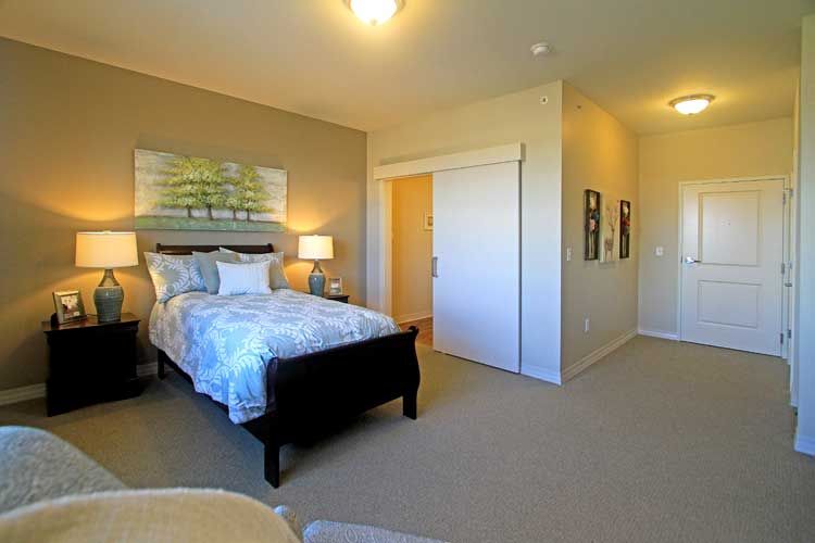 Corner view of a well-decorated bedroom in Cornerstone Senior Living Community, Grayslake.