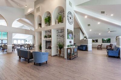 Interior view of The Grove senior living community featuring wood flooring and modern furniture.