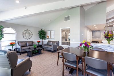 Interior view of The Grove senior living community featuring dining area, reception room, and decor.
