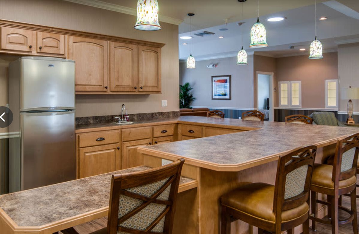 Interior view of The Arbors At Centennial Pointe senior living community featuring a well-designed kitchen and dining area.