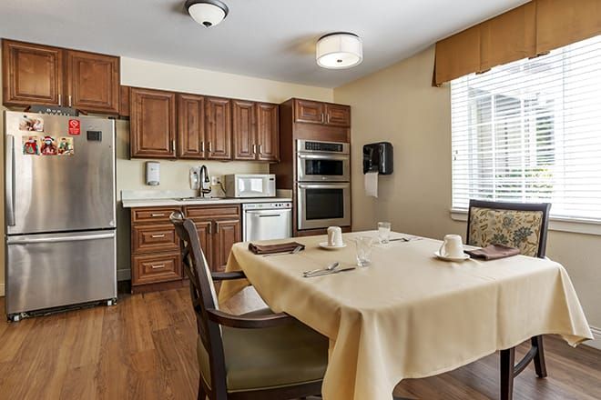 Interior view of Brookdale Auburn senior living community featuring dining room, kitchen appliances, and decor.
