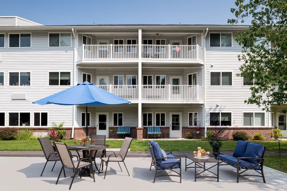 Senior living community, Anchor Bay at Pocasset, featuring high-rise apartments, urban architecture, and green spaces.