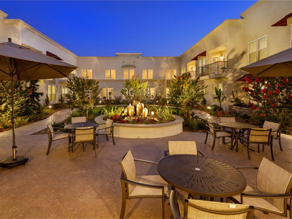 Oakmont of Torrance senior living community featuring villa-style housing, patio dining, and lush backyard.