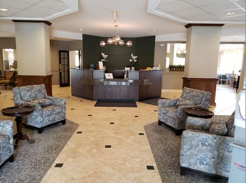 Senior living community, The Pointe at Eastgate, featuring elegant architecture, foyer, and furniture.