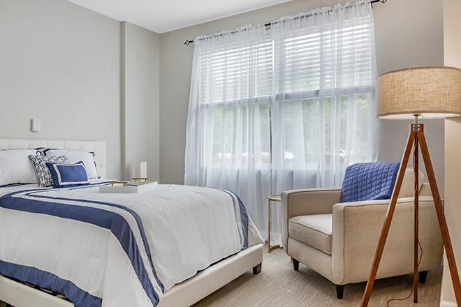 Interior design of a cozy bedroom with lamp and home decor at Brookdale Potomac senior living community.