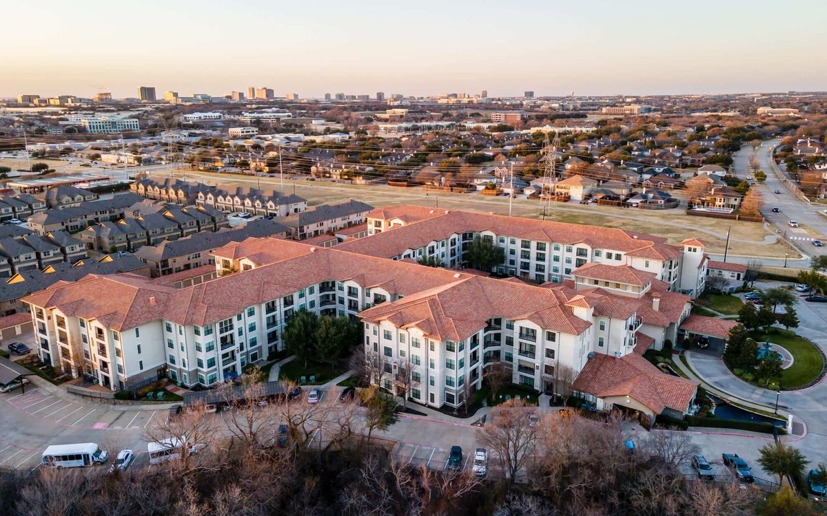 Aerial view of Conservatory At Plano senior living community with urban cityscape.