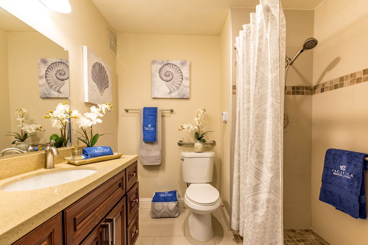 Interior view of Pacifica Senior Living San Leandro featuring a bathroom with stylish design and floral decor.