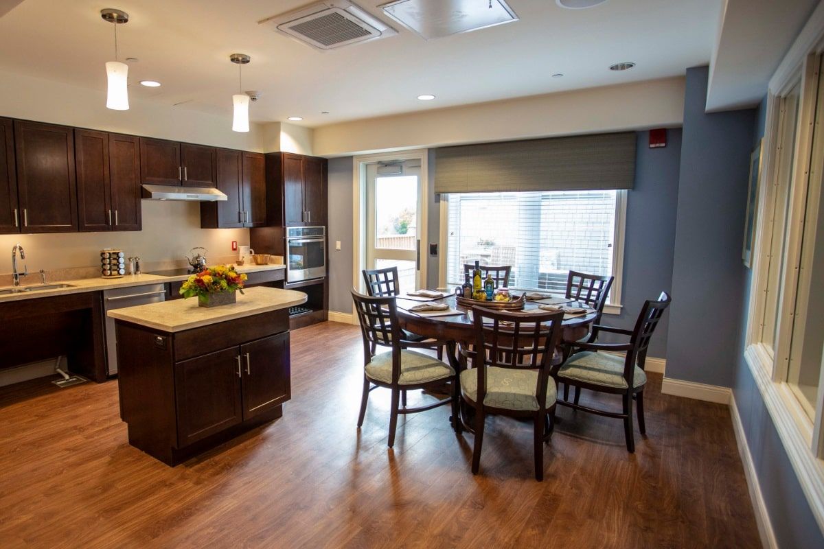 Interior view of Sturges Ridge Fairfield senior living community featuring dining and kitchen area.