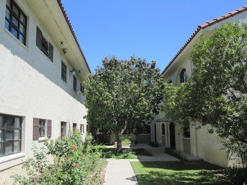 Mother Gertrude Home, a senior living villa in an urban neighborhood with lush oak and sycamore trees.