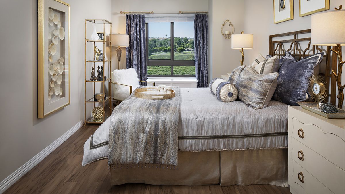 Interior design of a bedroom at Belmont Village Senior Living in Cardiff By The Sea, featuring home decor and furniture.