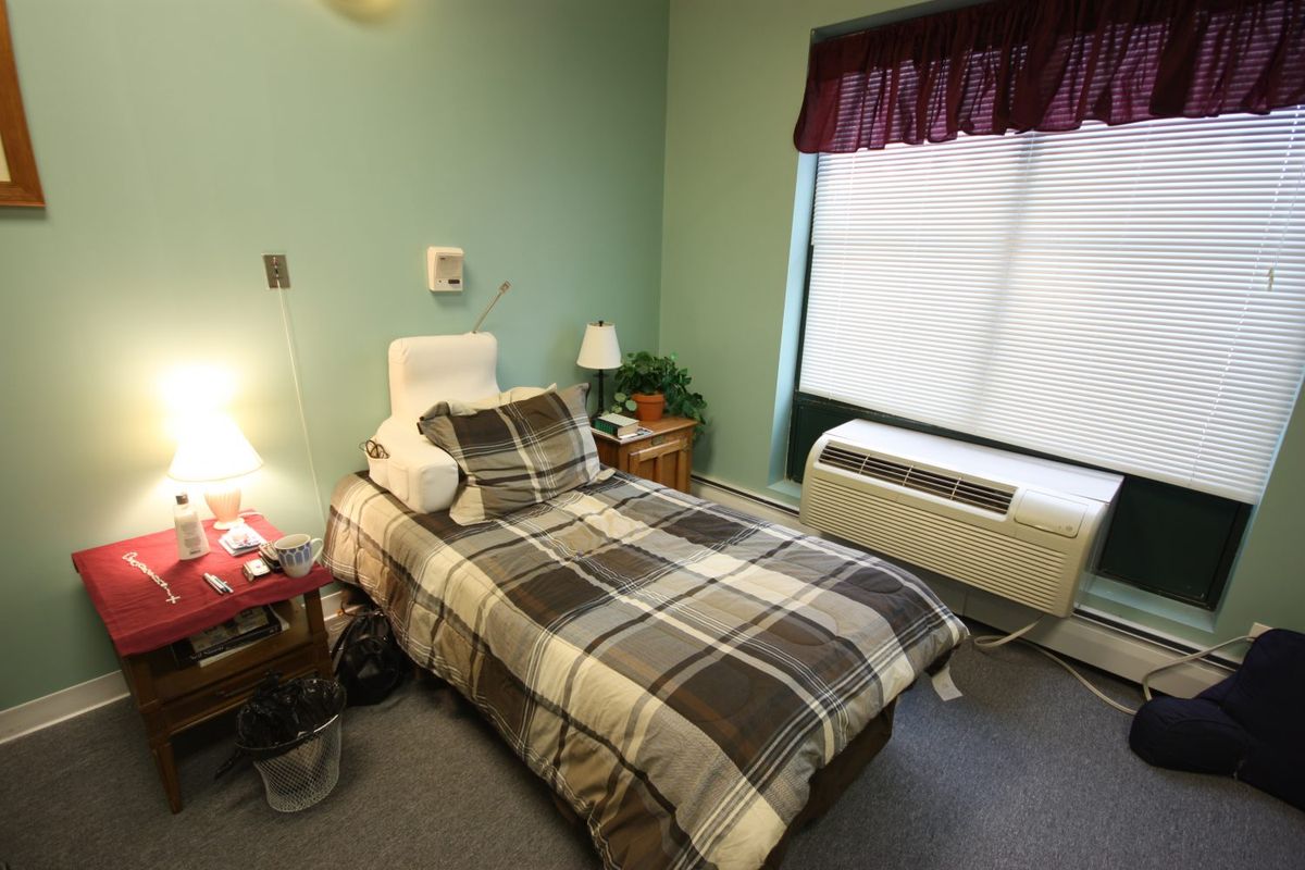 Senior living community bedroom at Heritage Woods of Chicago, featuring cozy furniture and home decor.