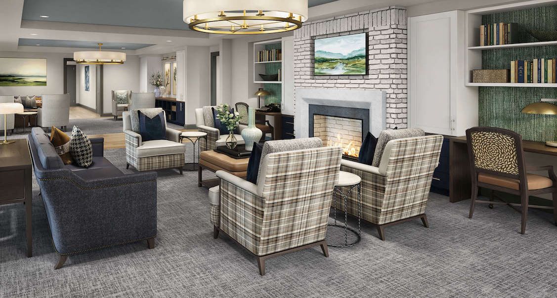 Senior living room at Arbor Terrace Basking Ridge with cozy fireplace and elegant furniture.