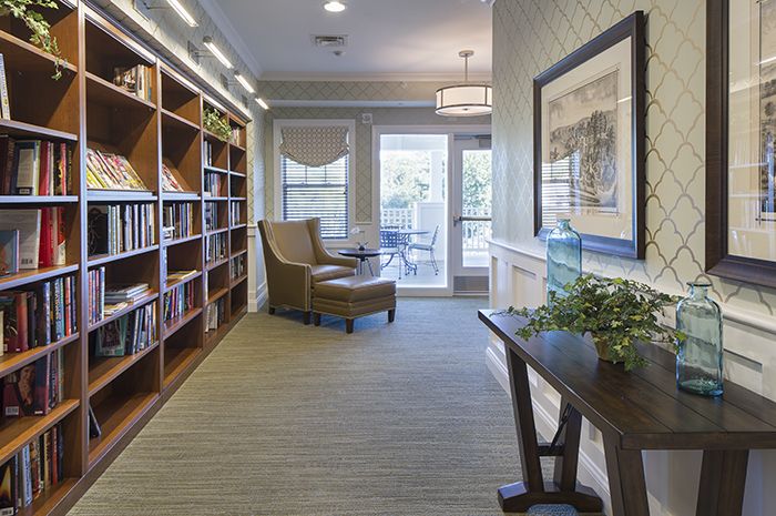 Interior view of Brightview Tenafly senior living community, featuring a library and living room.