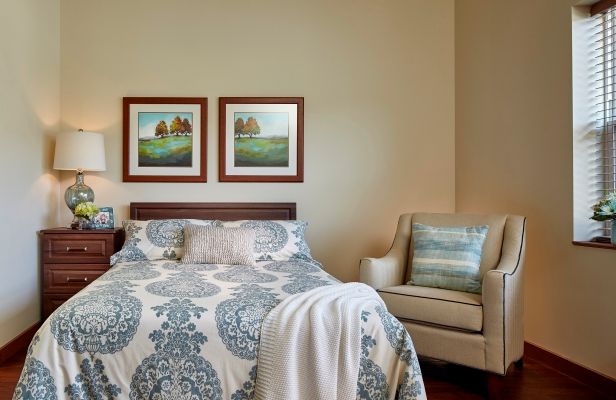 Interior design of a cozy bedroom at Terra Vista Of Oakbrook Terrace senior living community.