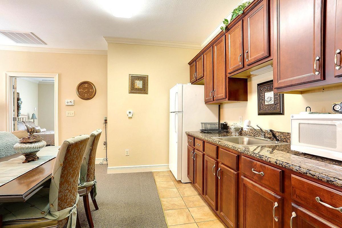 Interior view of Summerfield Senior Living in Slidell featuring a well-equipped kitchen and dining room.