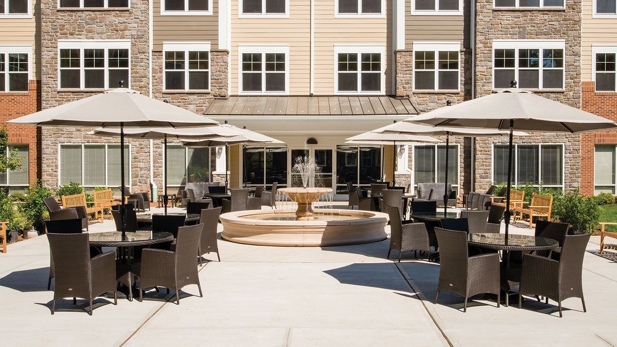 Urban senior living community at Lantern Hill featuring patio dining area with furniture.