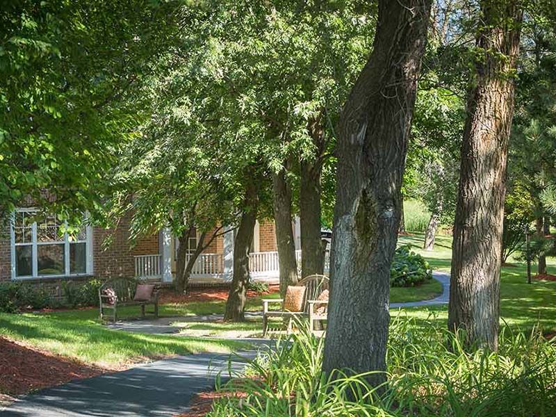 Scenic view of Atria Park of Glen Ellyn, a lush senior living community with park and garden.
