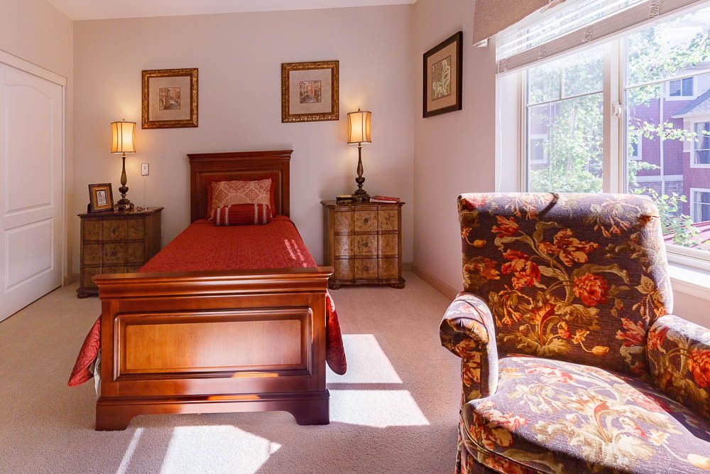 Interior design of a bedroom in Home Decor senior living community at Post Falls with cozy furniture.