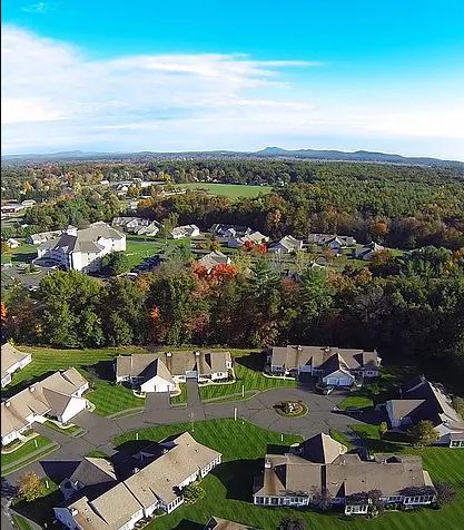Aerial view of American Inn at Sawmill Park, a suburban senior living community with houses and driveways.