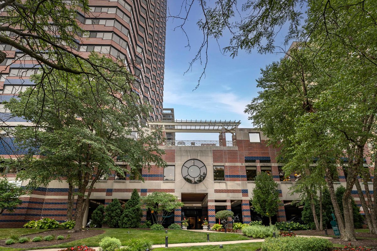 Senior living community, Brookdale Lake Shore Drive, featuring high-rise condos, clock tower, and urban greenery.