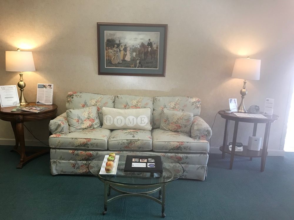 Senior resident relaxing in a well-furnished living room at HCR Manorcare senior living community.