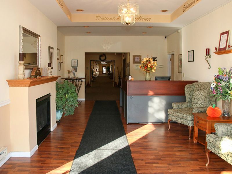 Interior view of DeSmet Retirement Community featuring hardwood floors, cozy furniture, and elegant decor.
