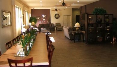 Senior living community Trinity Gardens on Portola featuring a well-furnished dining and living room.