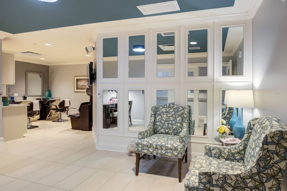 Interior view of Arbor Terrace Morris Plains senior living community featuring living room, beauty salon, and foyer.