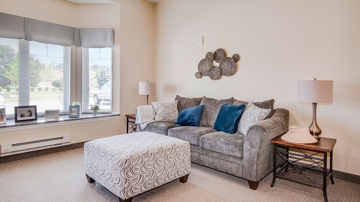 Comfortable furniture and home decor in the living area at Glen Abbey Assisted Living & Memory Care.