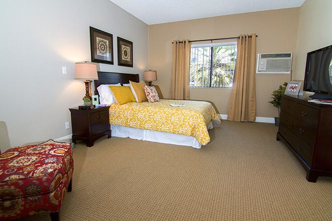 Senior living bedroom at Summit Assisted Living of Tarzana with modern furniture and electronics.
