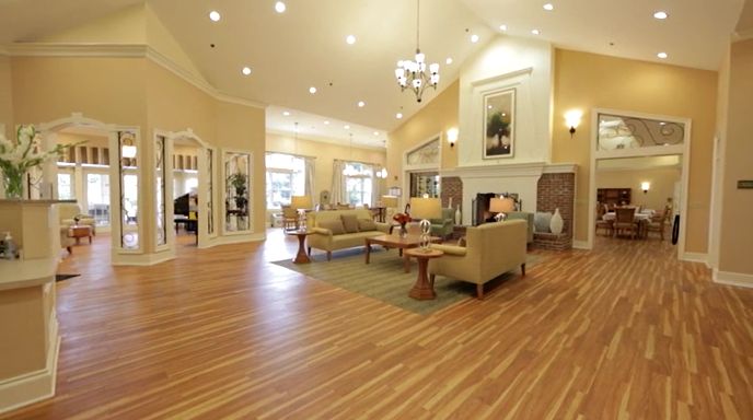 Interior view of CareOne at Moorestown senior living community featuring hardwood floors and elegant furniture.