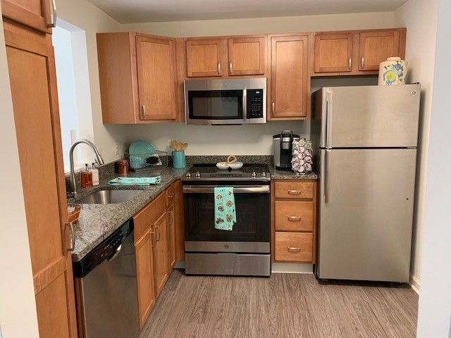 Interior view of a modern kitchen in Lions Gate senior living community with various appliances.