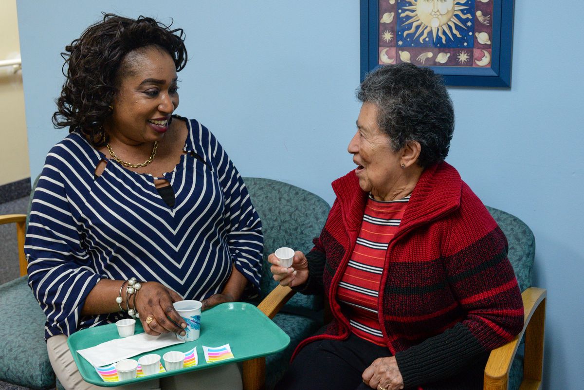 Residents at Winter Growth - Marge's Memory Care, engaging in conversation in a senior living community.