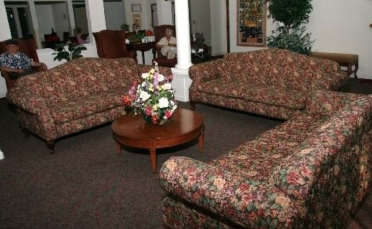 Senior man relaxing in the living room of St. Francis Assisted Care community home.
