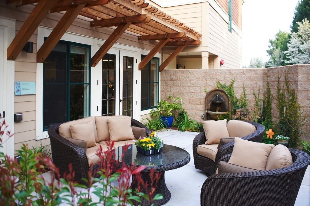 Senior living community at The Terraces of Los Gatos featuring patio, indoor living room and decor.
